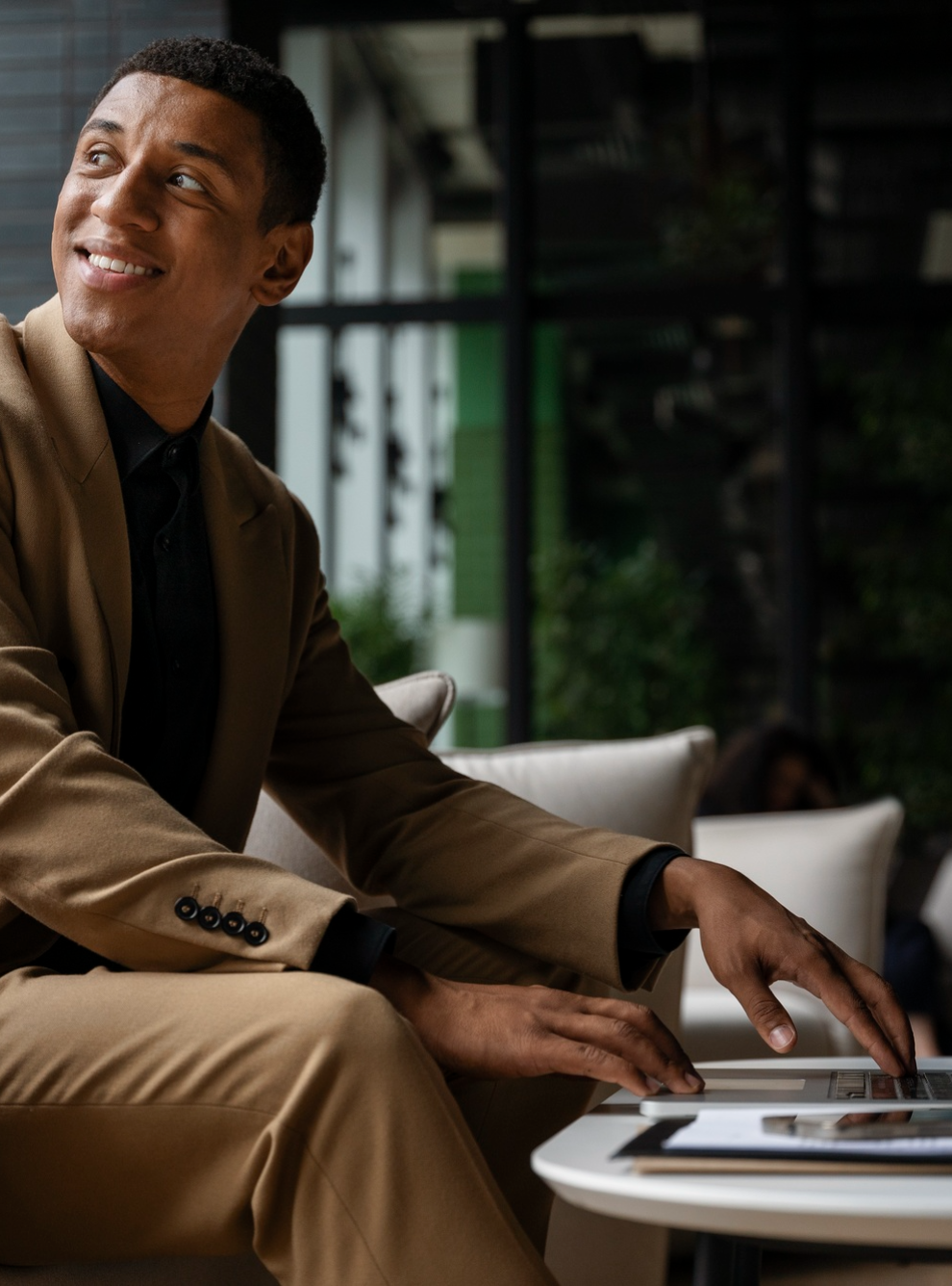 man in a suit using his laptop